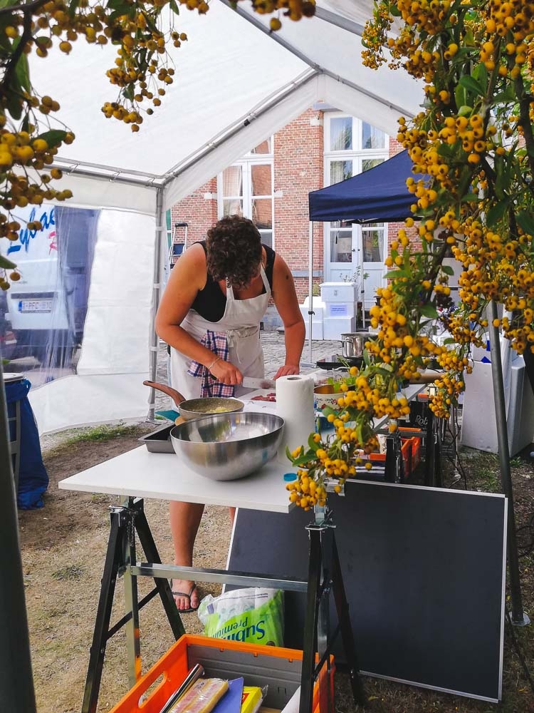 food stylist Eveline Boone working in outside kitchen under a partytent