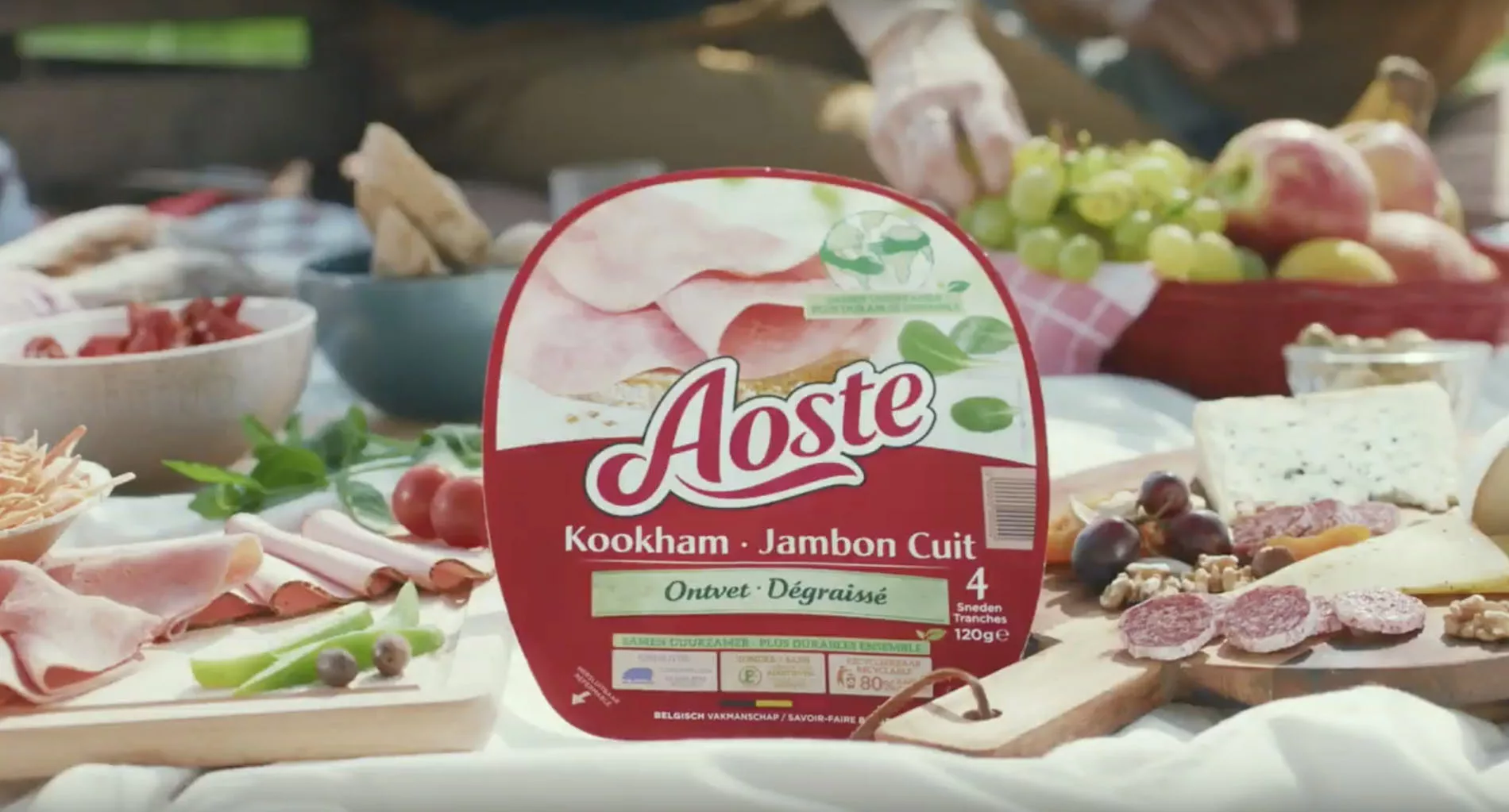 package of Aoste ham on a picnic blanket in the park