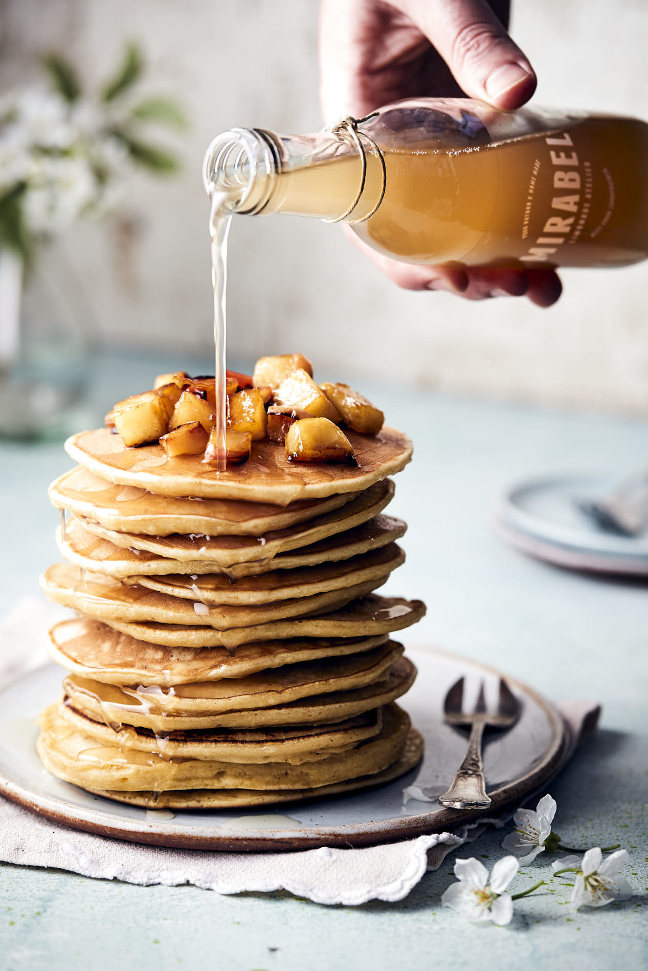 stack of american pancakes with Mirabel apple-cinnamon syrupliquid photography by French beans