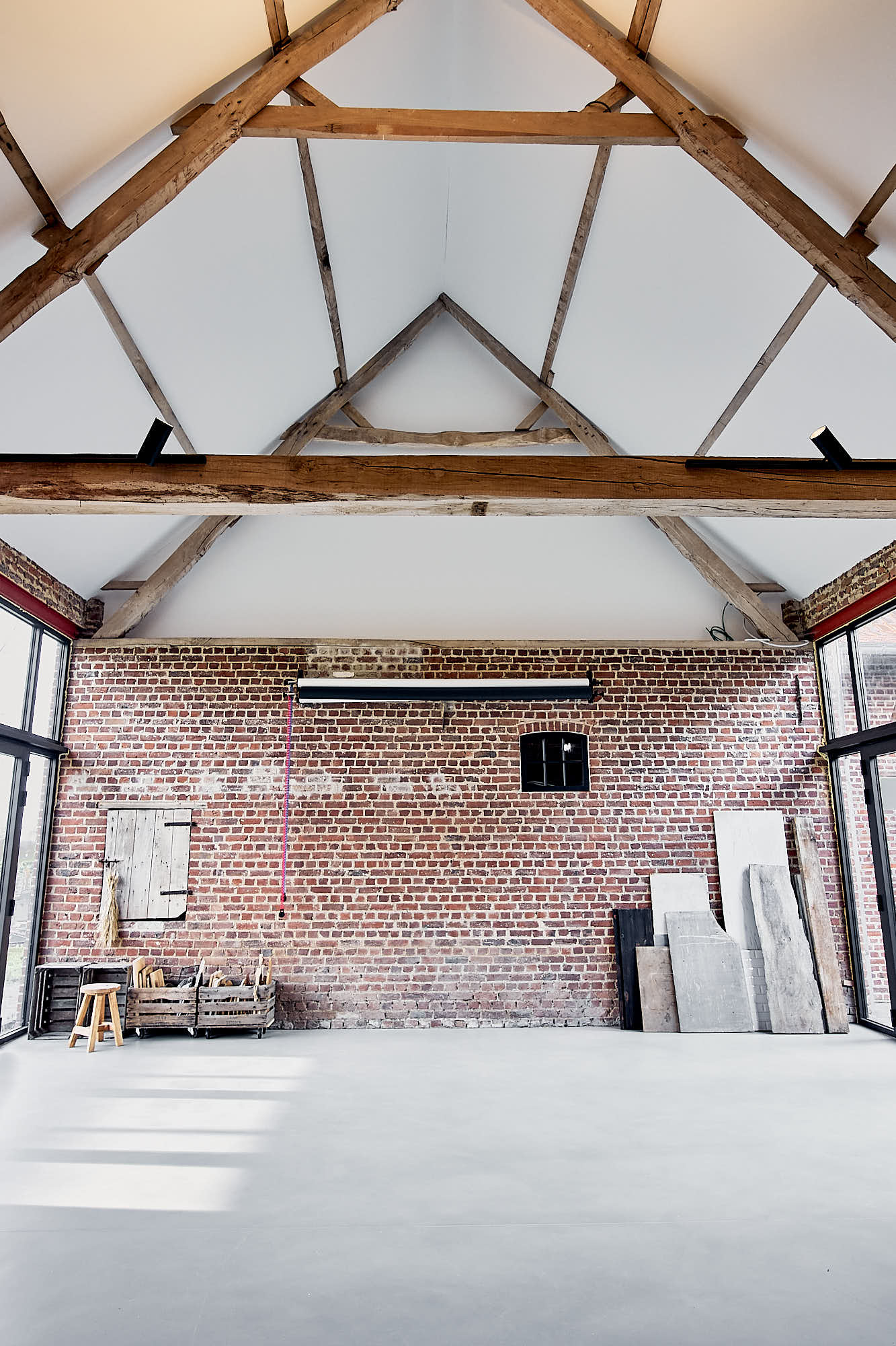 photography studio with high ceiling and brick walls