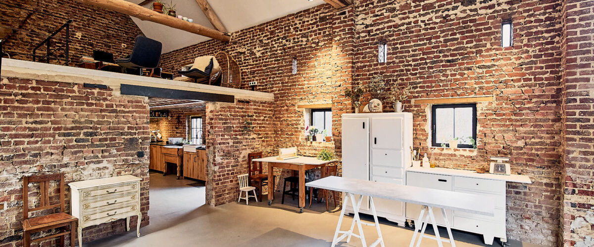 Modular Set Furniture In A Rustic Studio Space And A Kichen In The Background